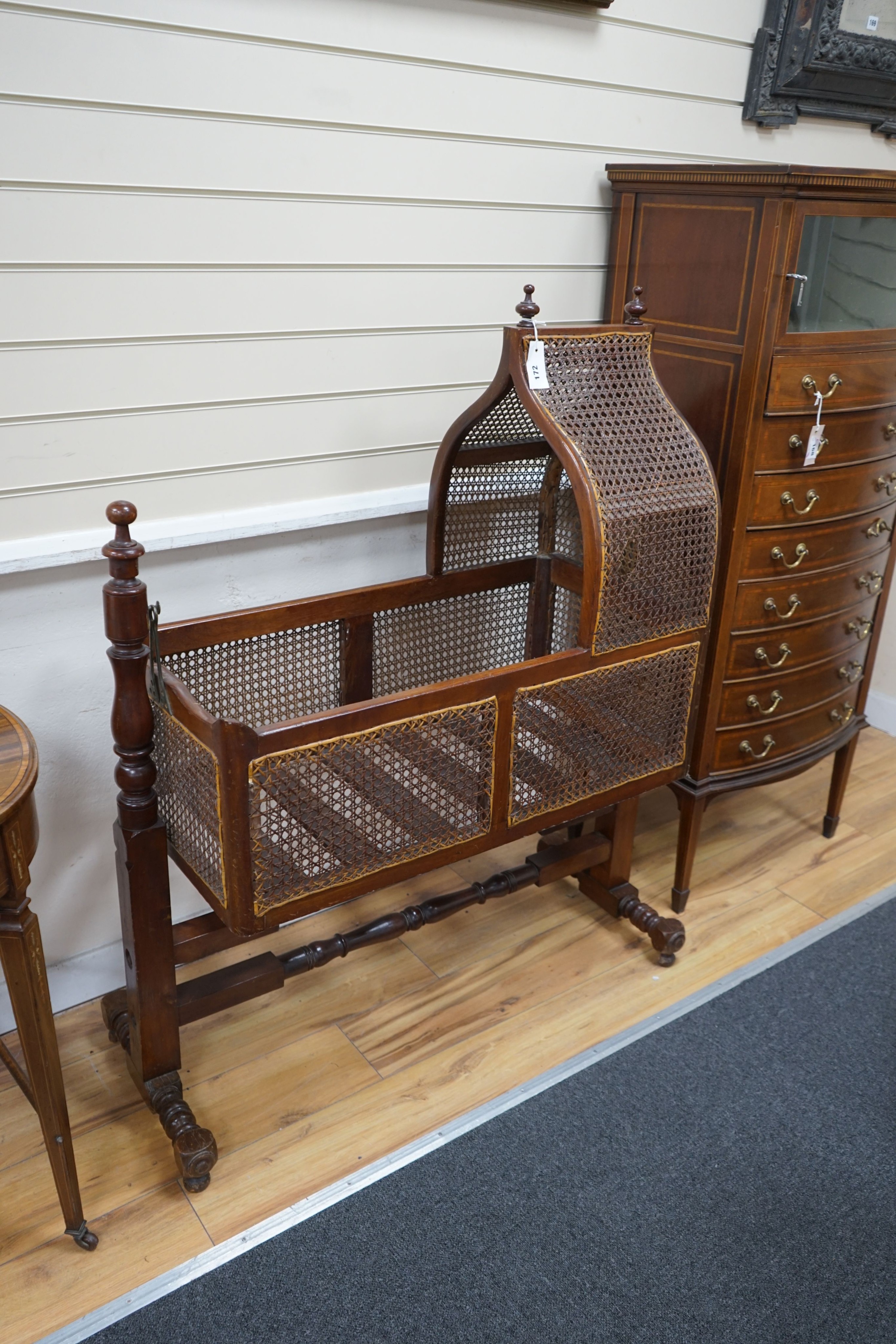 A Victorian caned mahogany rocking cradle with arched canopy, width 100cm, depth 41cm, height 124cm